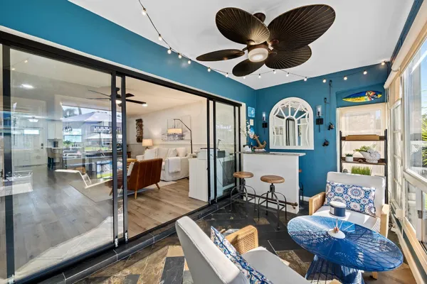 a living room with lots of furniture and a large window