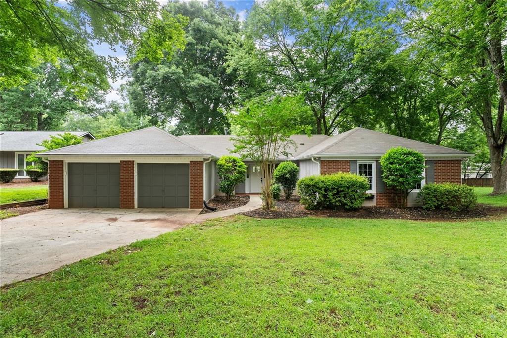 215 Truehedge Trace Roswell, GA 30076 - Photo 1 of 1 a front view of a house with a garden and yard