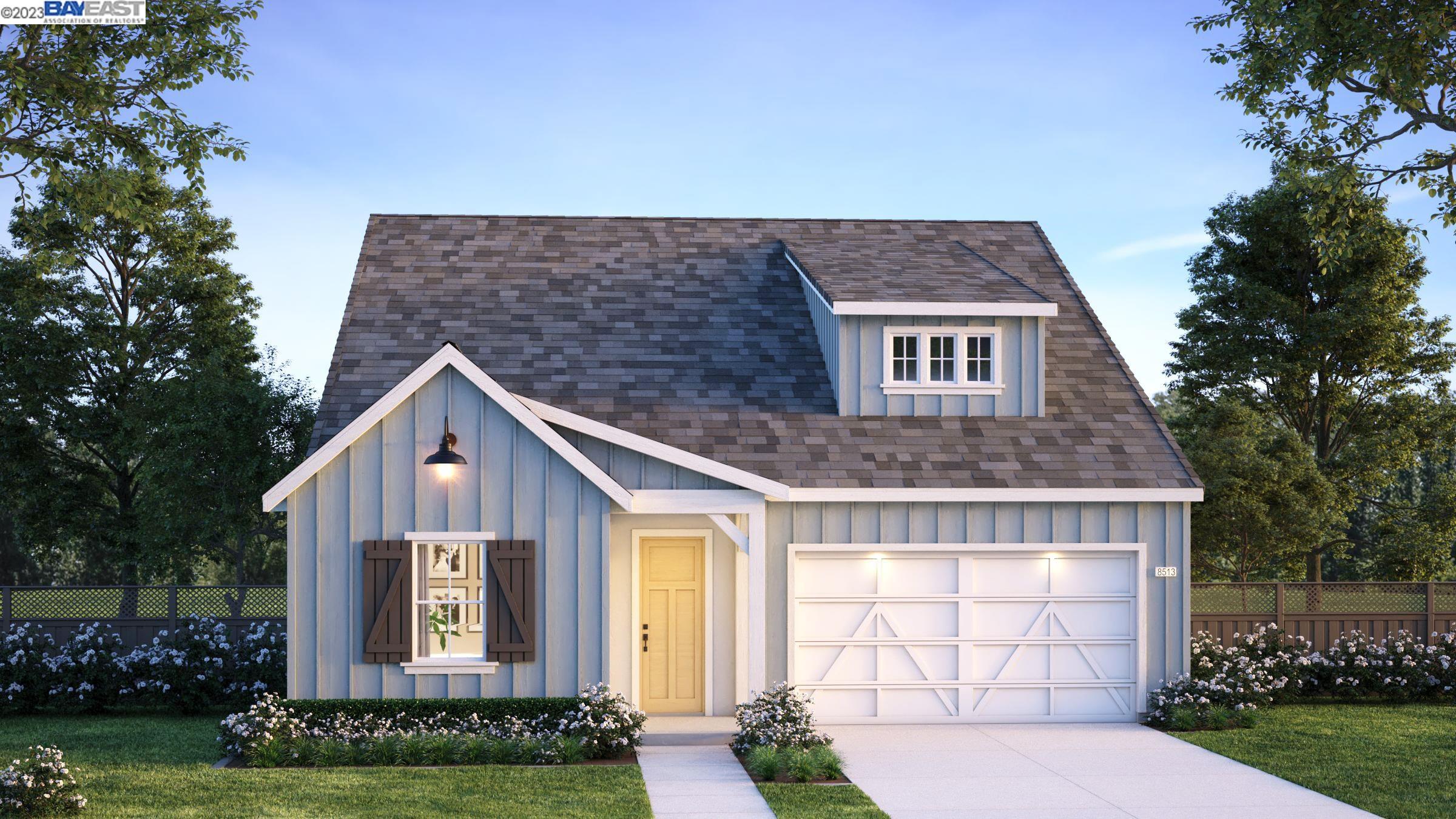 a front view of a house with a garden and plants