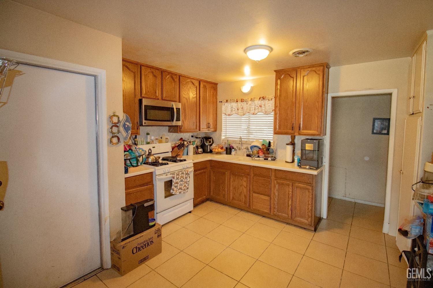 Undisclosed Address Bakersfield, CA 93306 - Photo 2 of 9 a kitchen with stainless steel appliances granite countertop a refrigerator and a stove top oven