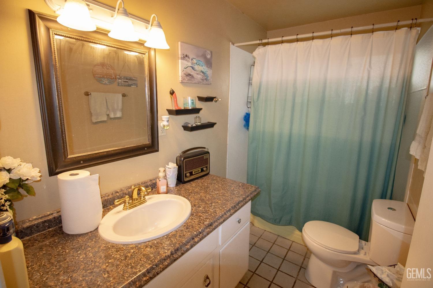 Undisclosed Address Bakersfield, CA 93306 - Photo 4 of 9 a bathroom with a granite countertop sink toilet and shower