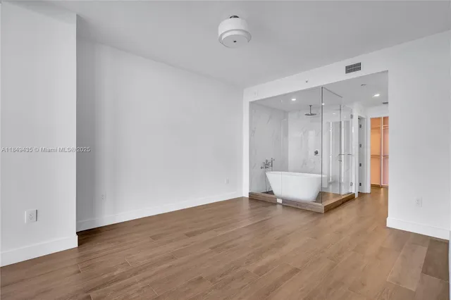 a living room with furniture and large windows