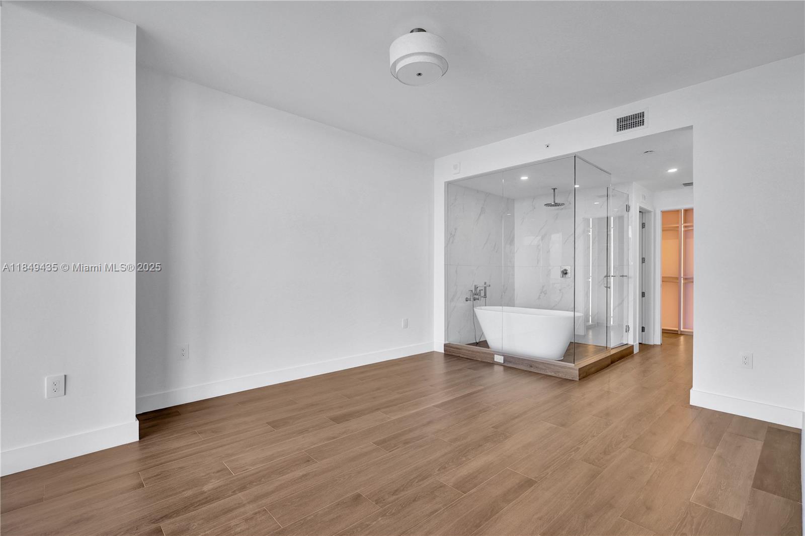 700 Northeast 24th Street, Unit 4005 Miami, FL 33137 - Photo 11 of 89 a view of an empty room with wooden floor