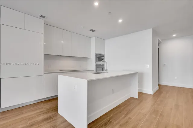 a bathroom with a toilet a sink and shower