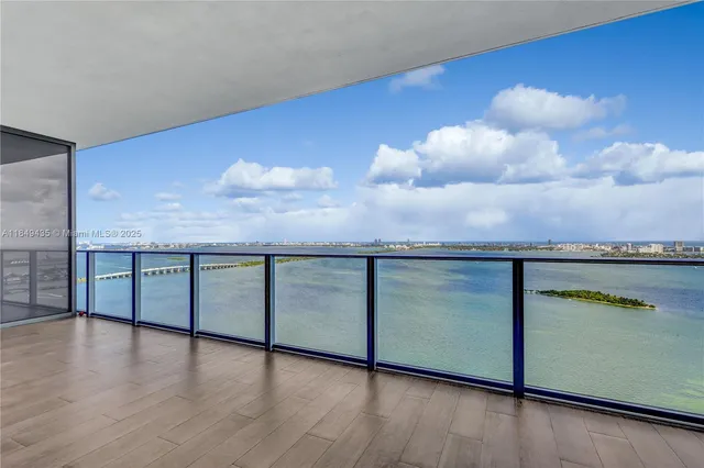 a kitchen with kitchen island granite countertop a stove and a wooden floors