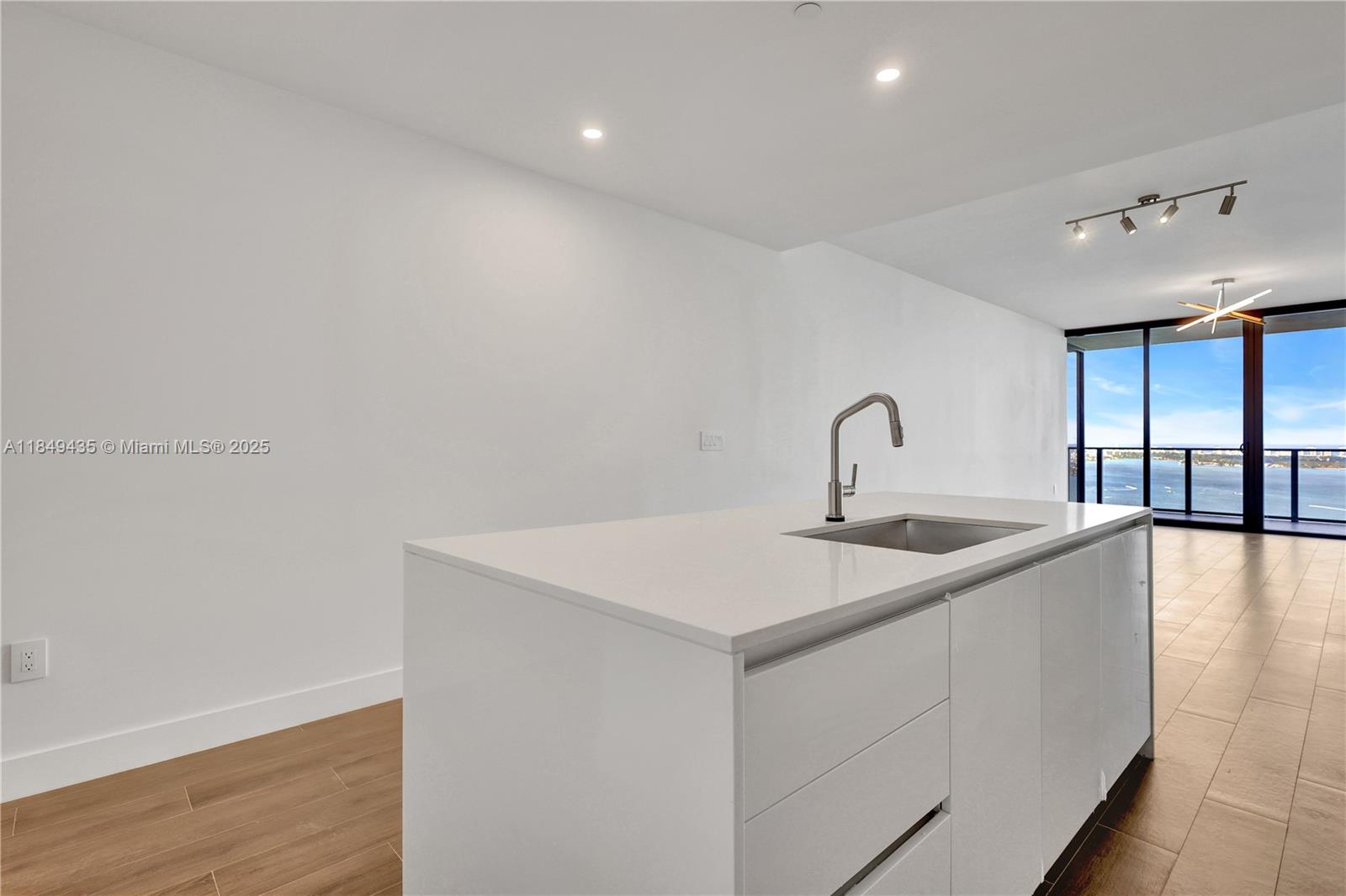 700 Northeast 24th Street, Unit 4005 Miami, FL 33137 - Photo 23 of 89 a kitchen with a sink and cabinets