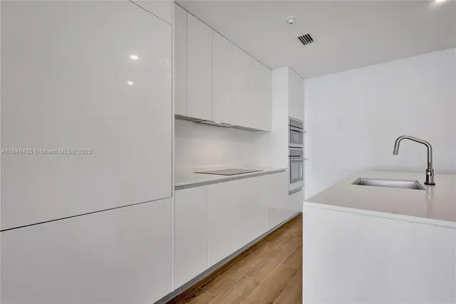 an outdoor sitting area with furniture and umbrella
