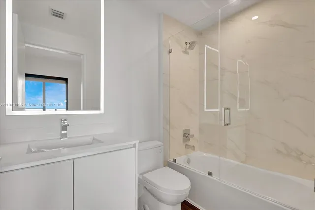 a view of an empty room with wooden floor and iron fence