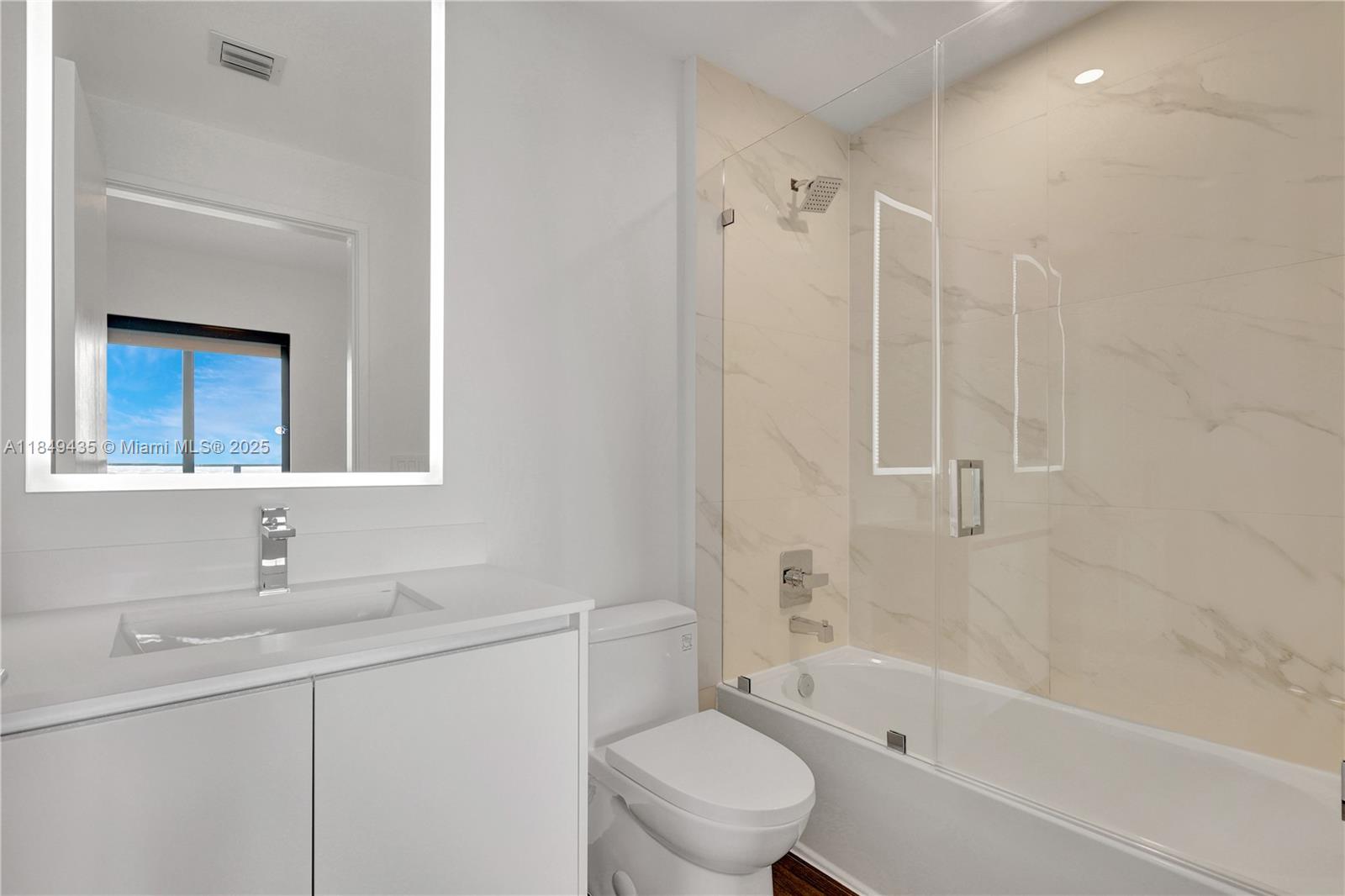 700 Northeast 24th Street, Unit 4005 Miami, FL 33137 - Photo 35 of 89 a bathroom with a sink toilet vanity and shower