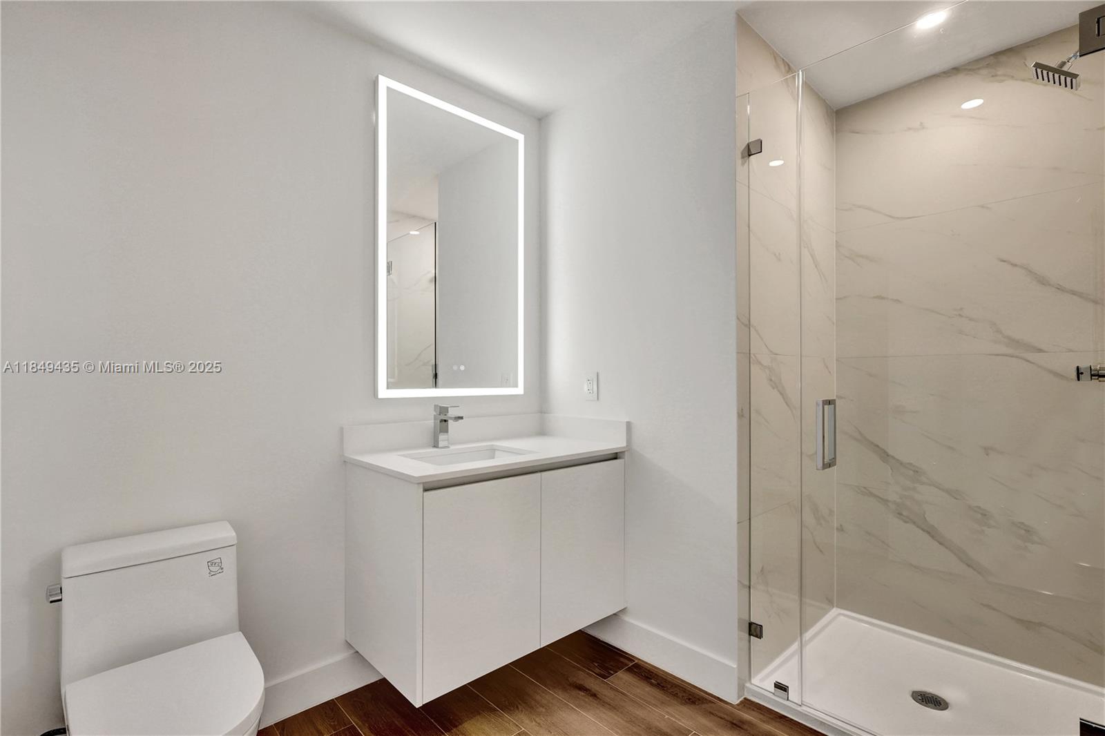 700 Northeast 24th Street, Unit 4005 Miami, FL 33137 - Photo 38 of 89 a bathroom with a toilet a sink and shower