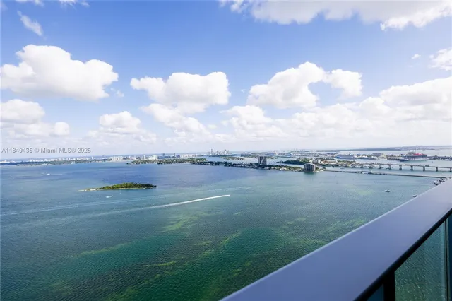 a view of a room with wooden floors and ceiling fan