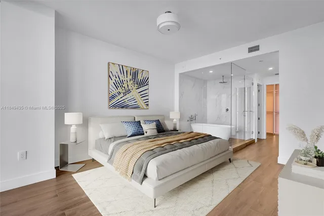 a bedroom with a large bed and a large window