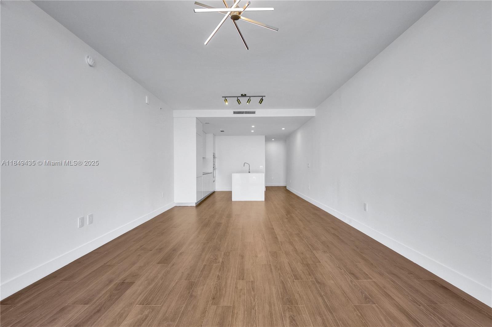 700 Northeast 24th Street, Unit 4005 Miami, FL 33137 - Photo 10 of 89 a view of a room with wooden floors and ceiling fan