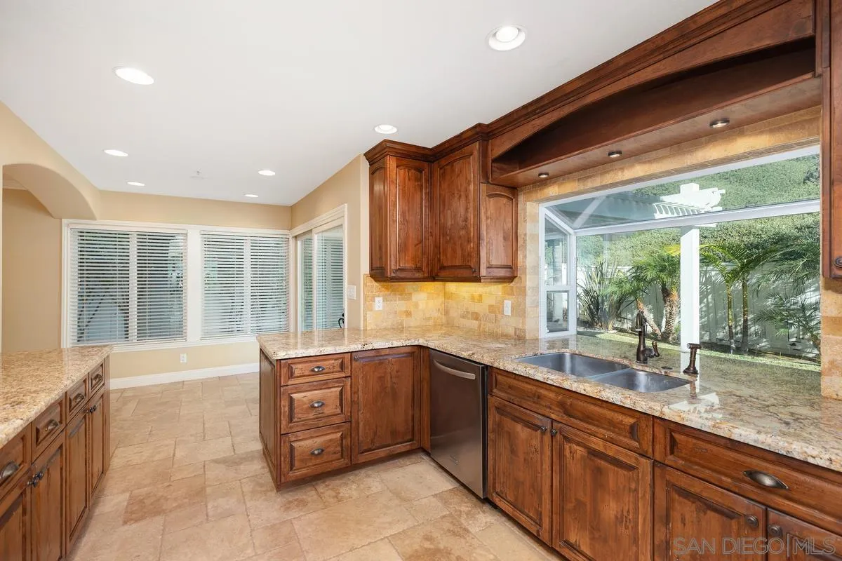 2002 Paseo Laro San Clemente, CA 92673 - Photo 15 of 37 a large kitchen with kitchen island a large window a sink and stainless steel appliances