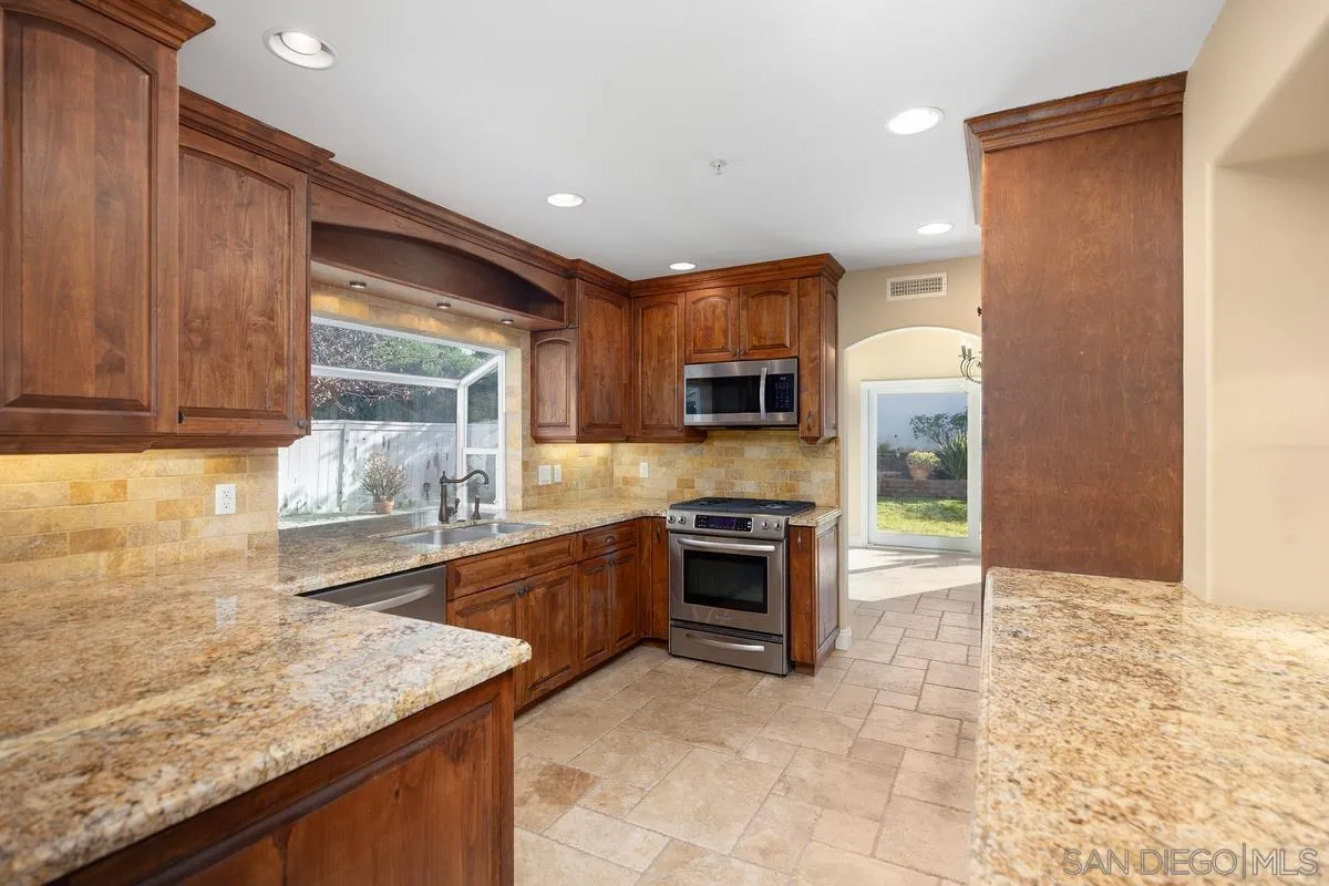 2002 Paseo Laro San Clemente, CA 92673 - Photo 16 of 37 a kitchen with stainless steel appliances granite countertop a sink stove and oven