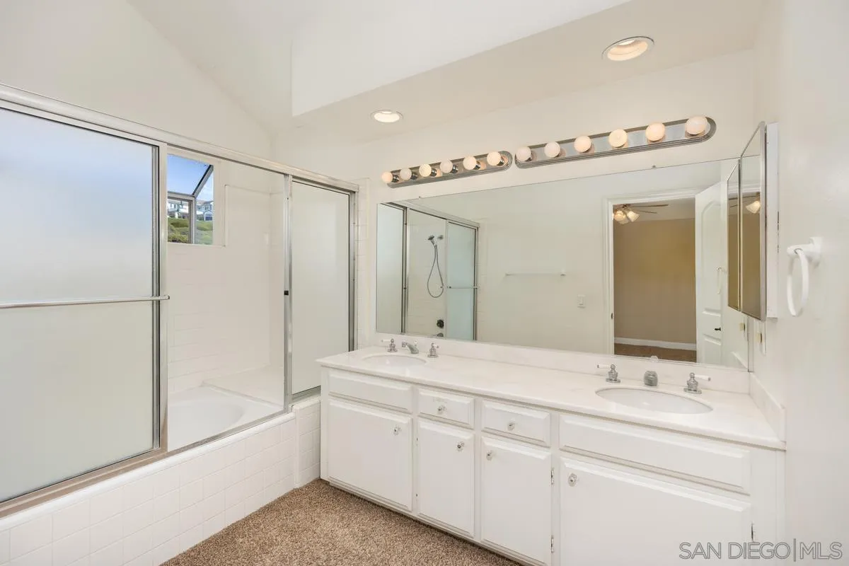 2002 Paseo Laro San Clemente, CA 92673 - Photo 32 of 37 a bathroom with a double vanity sink mirror double and a bathtub