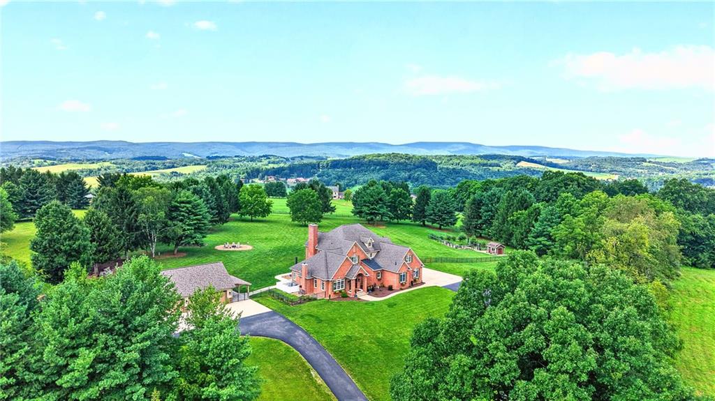 This magnificent 4 Bed, 6 Full and 1 Half Bath home sits on over 11 acres of privacy in the rolling hills of historic Ligonier.
