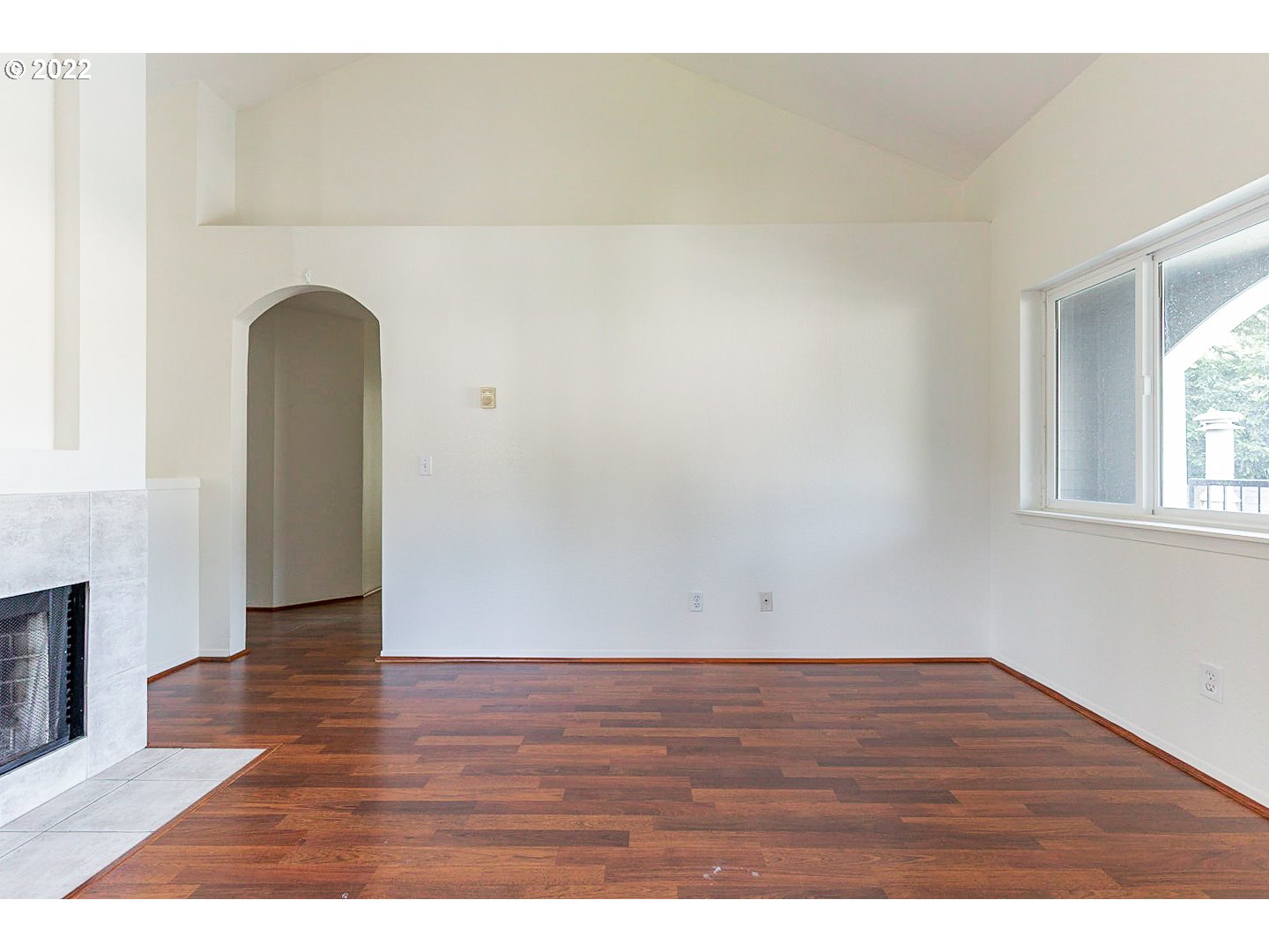 5225 Jean Road, Unit 207 Lake Oswego, OR 97035 - Photo 12 of 29 a view of an empty room with wooden floor and a window