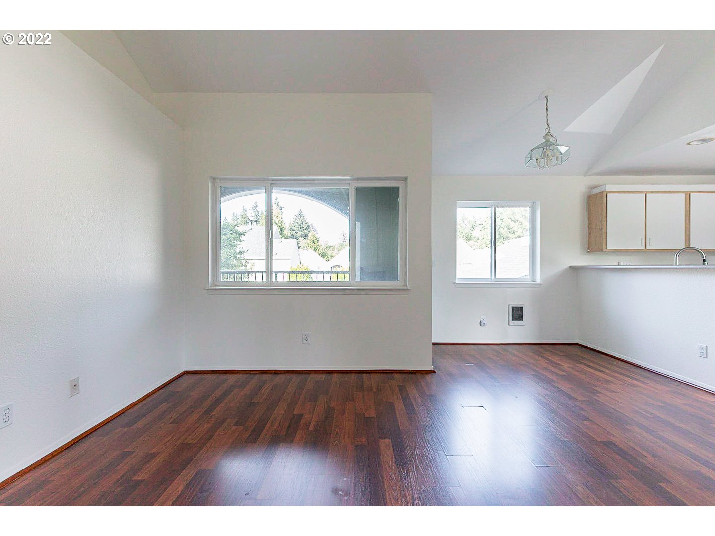 5225 Jean Road, Unit 207 Lake Oswego, OR 97035 - Photo 13 of 29 a view of an empty room with wooden floor and a window