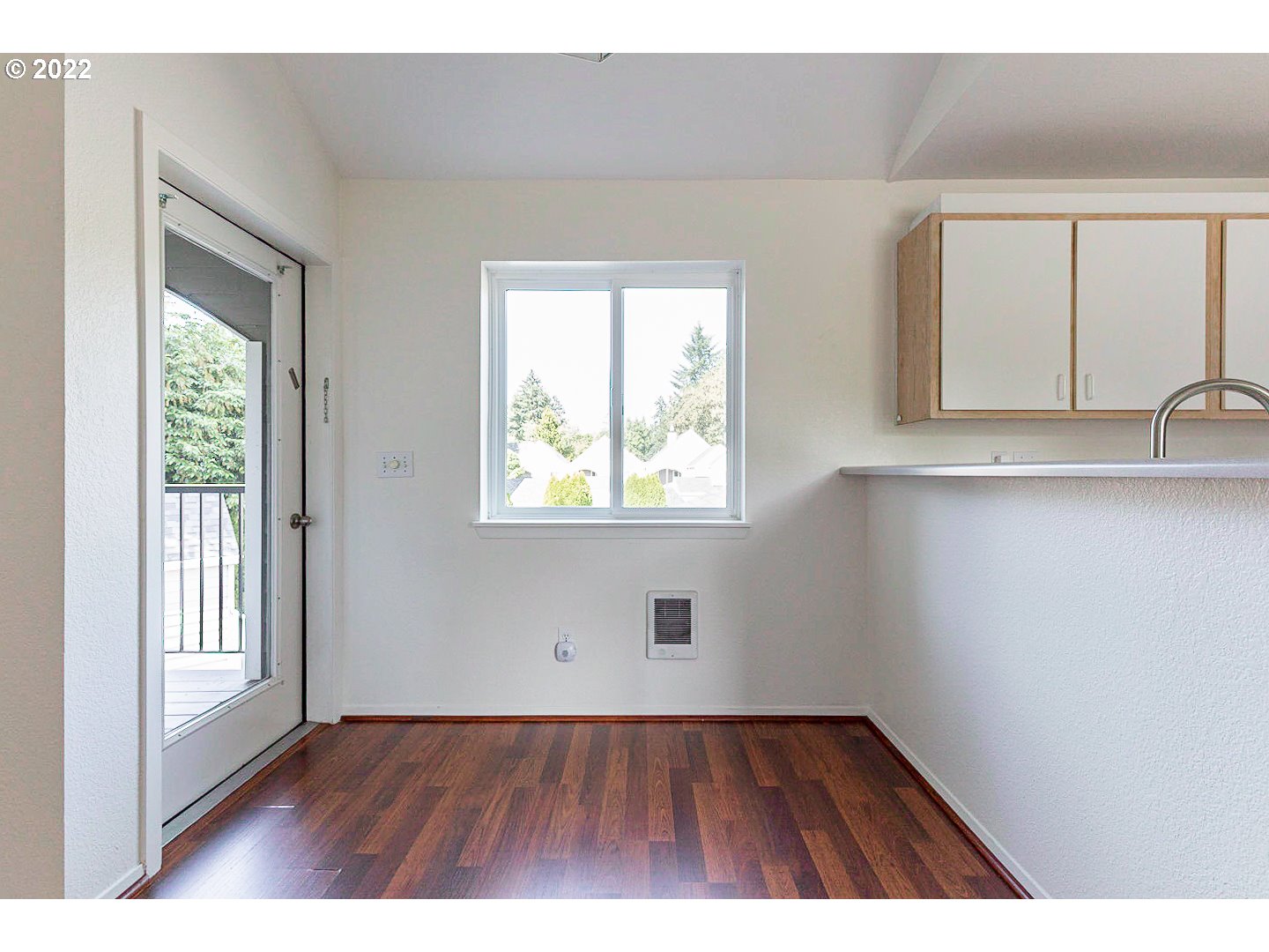 5225 Jean Road, Unit 207 Lake Oswego, OR 97035 - Photo 9 of 29 a view of an empty room with wooden floor and a window