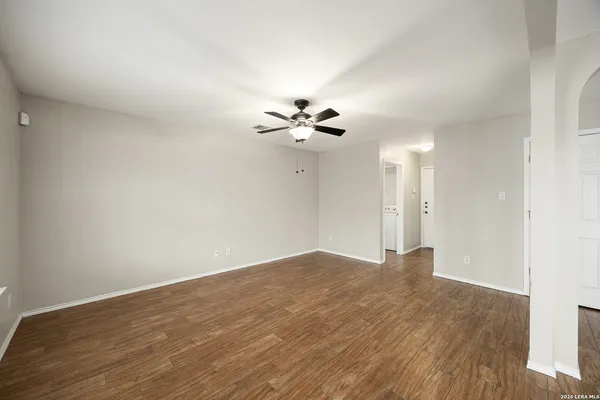 a view of an empty room with a ceiling fan
