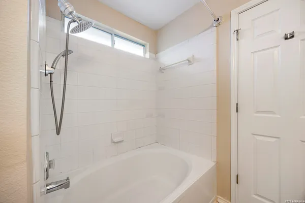 a bathroom with a bathtub and a shower