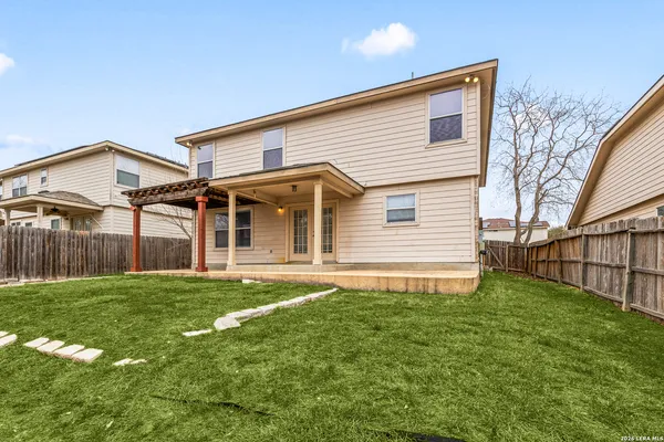 an aerial view of a house with swimming pool and a yard