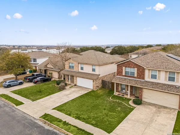 an aerial view of residential houses with outdoor space and swimming pool
