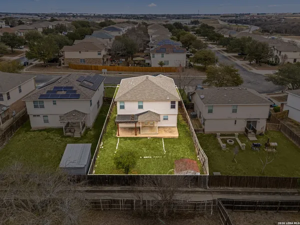 an aerial view of residential houses with outdoor space