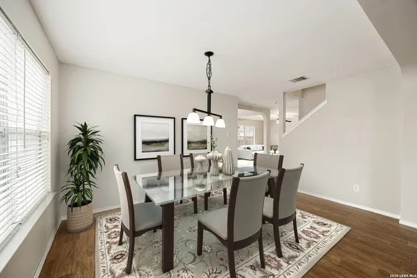 a dining room with furniture window and wooden floor