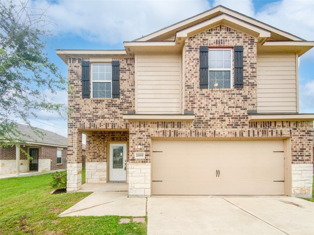 20000 Woodrow Wilson Street Manor, TX 78653 - Photo 1 of 1 a front view of a house with garden