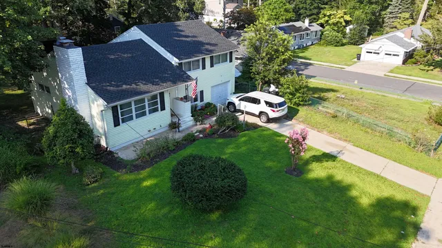 a aerial view of a house with swimming pool garden and patio