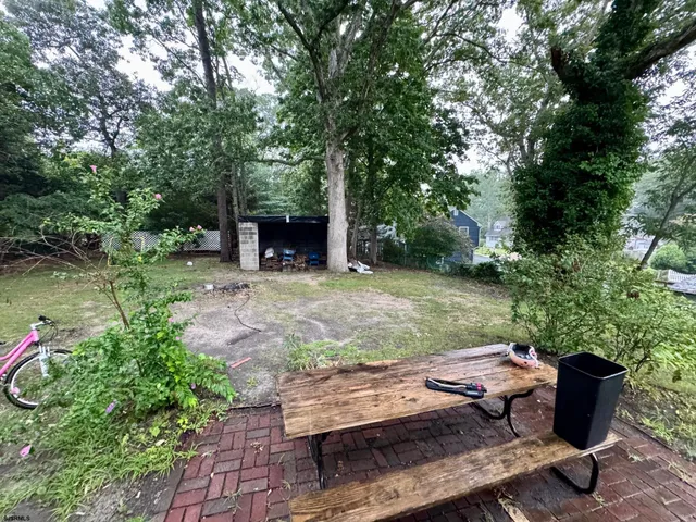 a view of backyard with seating area and green space