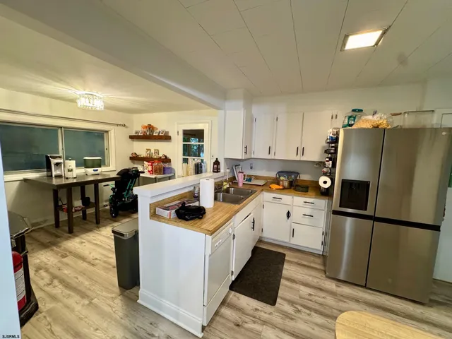 a kitchen with a sink appliances and cabinets