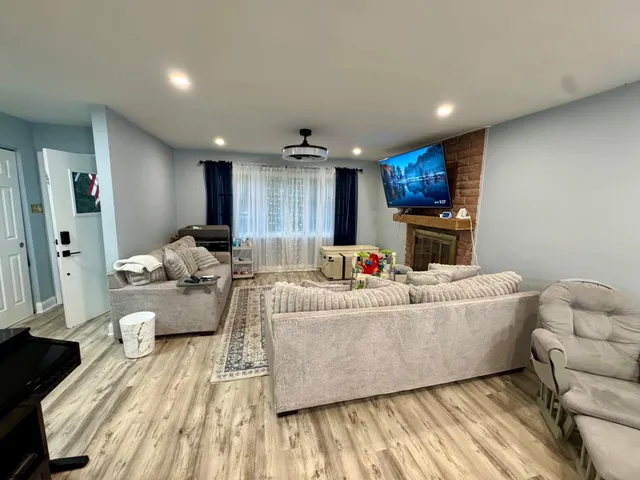 a living room with furniture and a wooden floor