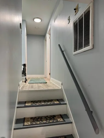 a view of a livingroom with furniture and floor to ceiling window