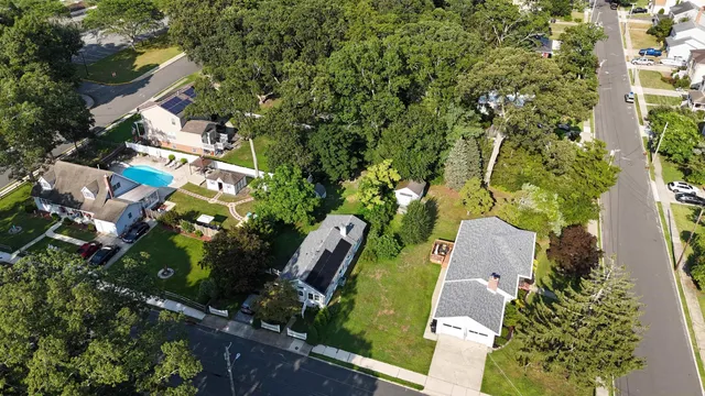 an aerial view of a house with a yard and garden