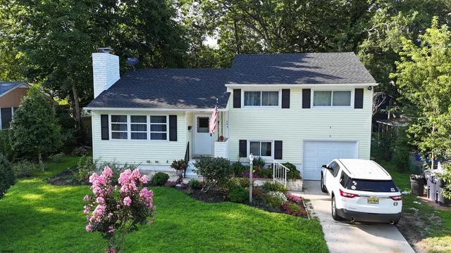 a aerial view of a house with garden and trees