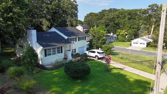 a view of a house with a backyard and a garden