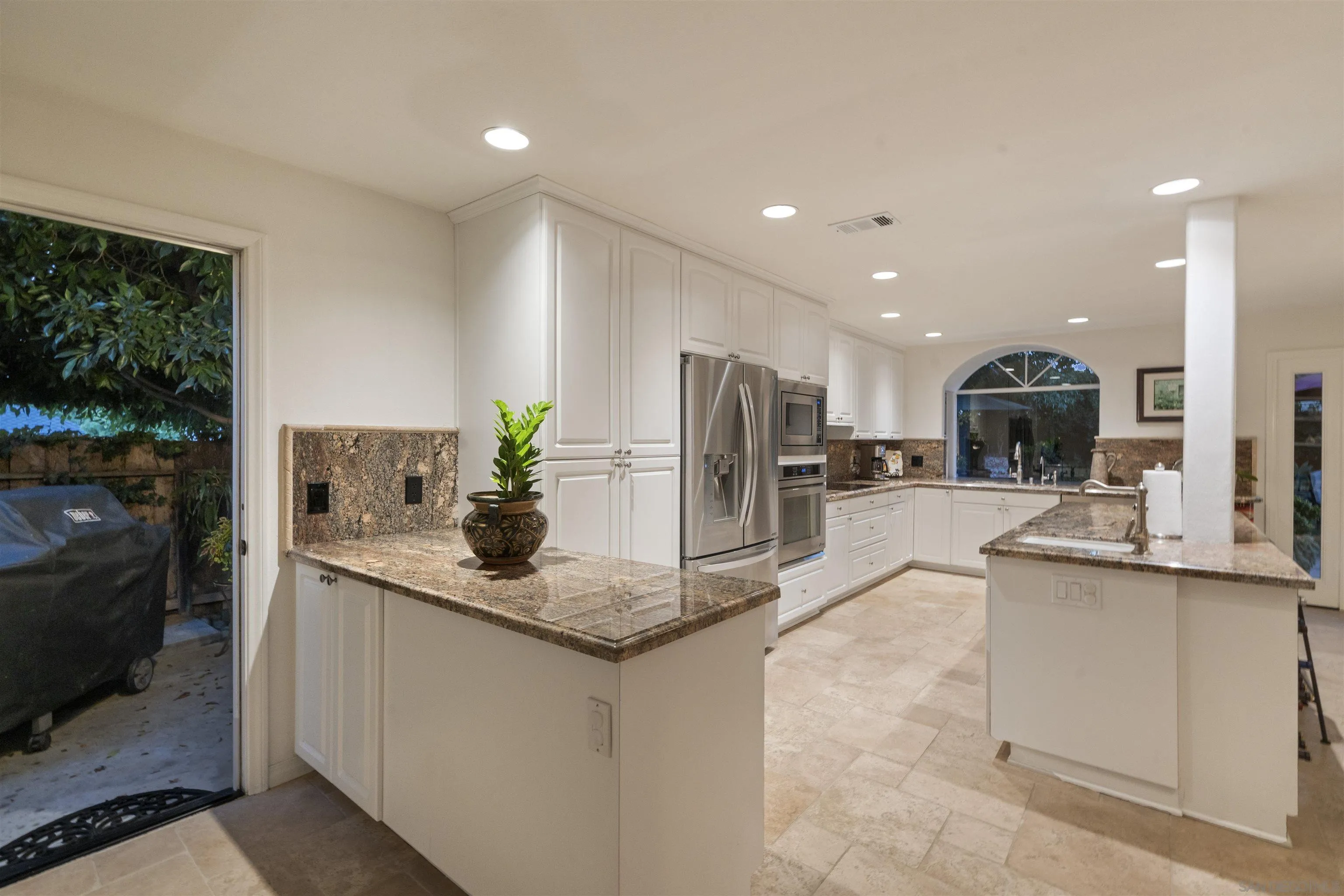 6502 La Paloma Street Carlsbad, CA 92009 - Photo 14 of 60 a kitchen with stainless steel appliances granite countertop a sink a refrigerator and a granite counter tops