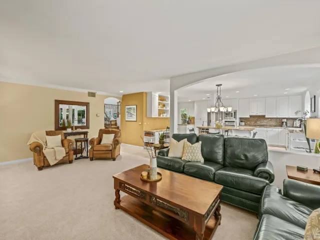 a dining room with furniture a flat screen tv and a large window