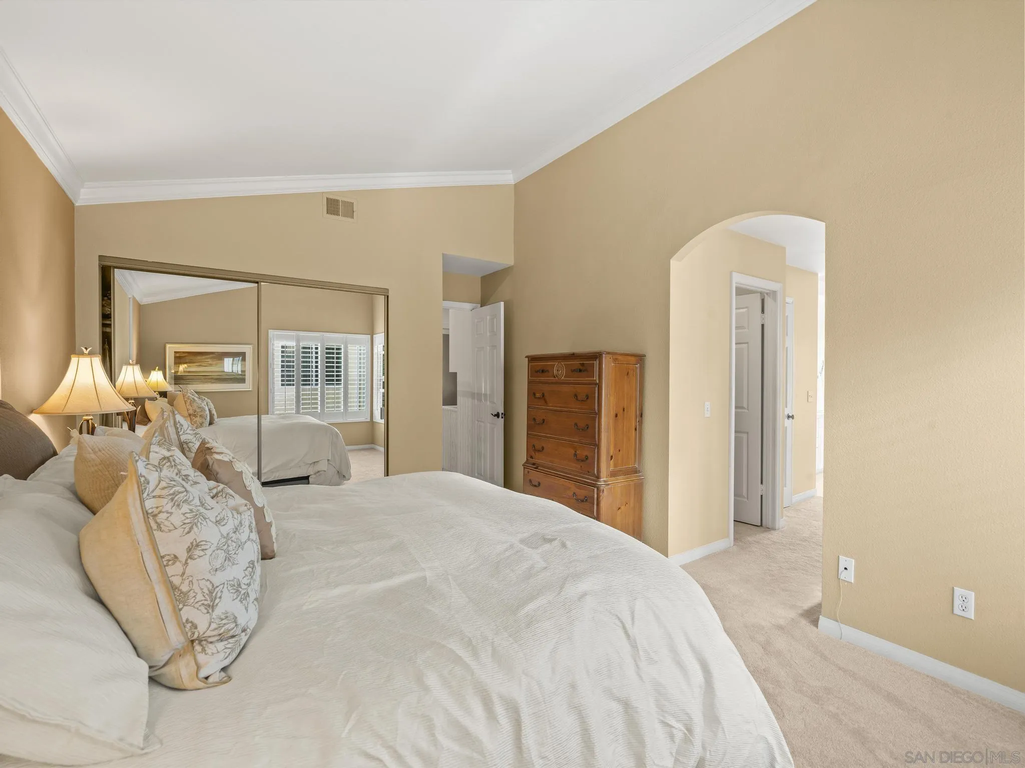 6502 La Paloma Street Carlsbad, CA 92009 - Photo 26 of 60 a spacious bedroom with a bed and a chandelier