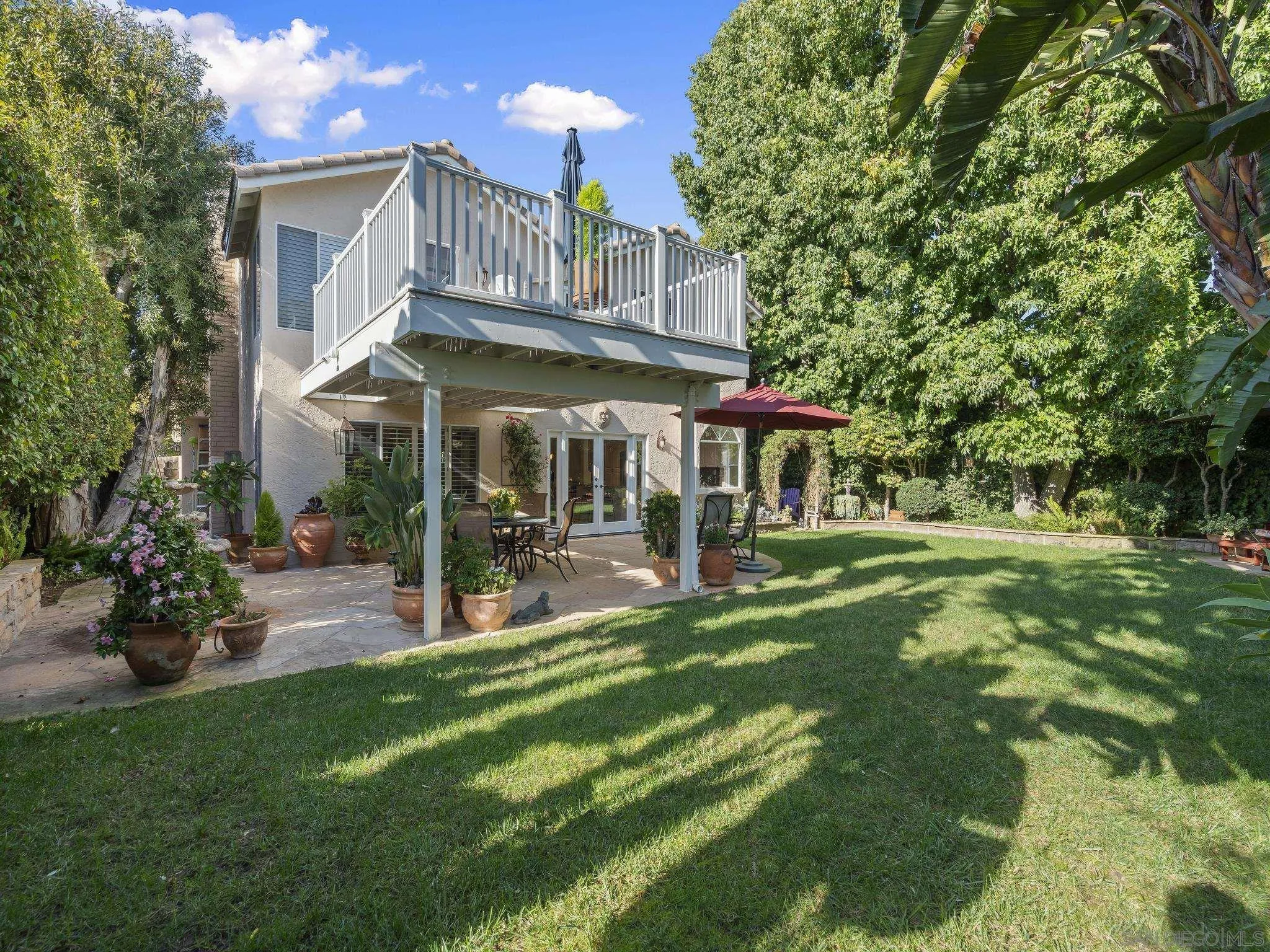 6502 La Paloma Street Carlsbad, CA 92009 - Photo 35 of 60 a view of a house with a yard porch and sitting area