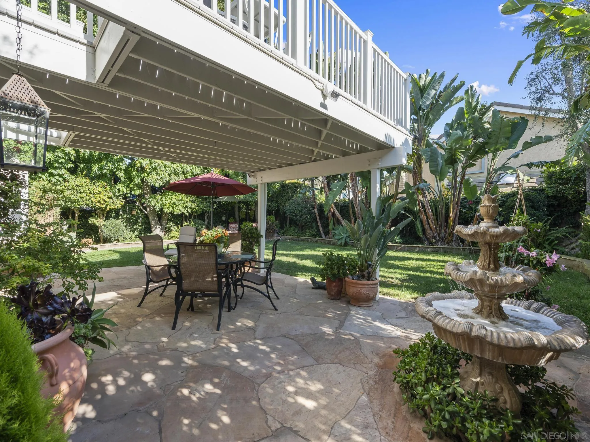 6502 La Paloma Street Carlsbad, CA 92009 - Photo 36 of 60 a view of a patio with table and chairs potted plants and floor to ceiling window