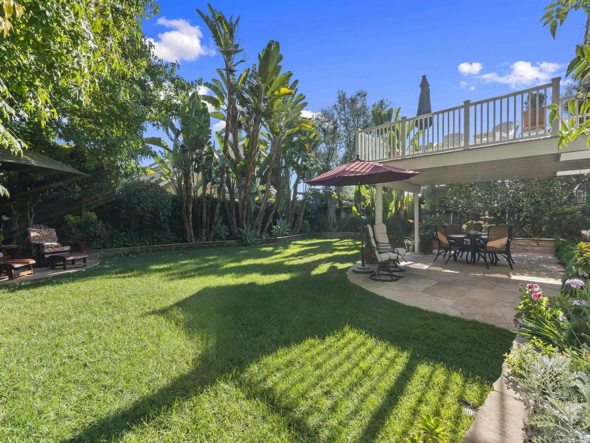 6502 La Paloma Street Carlsbad, CA 92009 - Photo 37 of 60 a view of a backyard with sitting area and slide