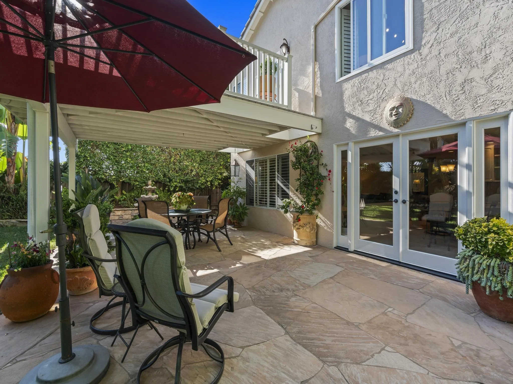 6502 La Paloma Street Carlsbad, CA 92009 - Photo 38 of 60 a view of a patio with table and chairs under an umbrella