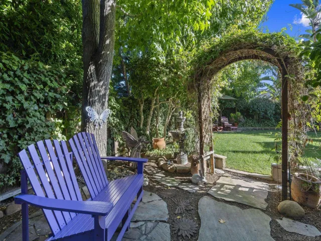 a view of a patio with table and chairs under an umbrella
