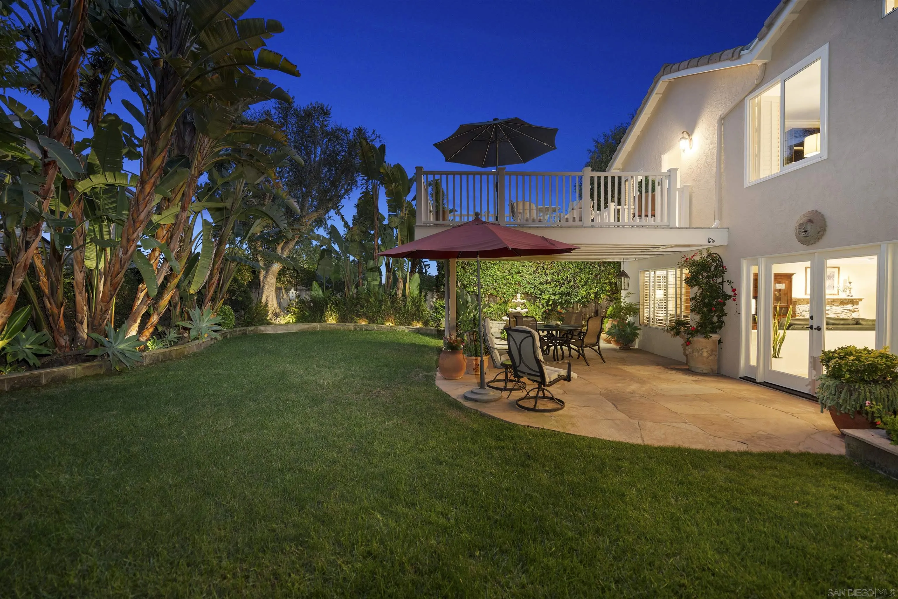 6502 La Paloma Street Carlsbad, CA 92009 - Photo 51 of 60 a view of a patio with table and chairs under an umbrella