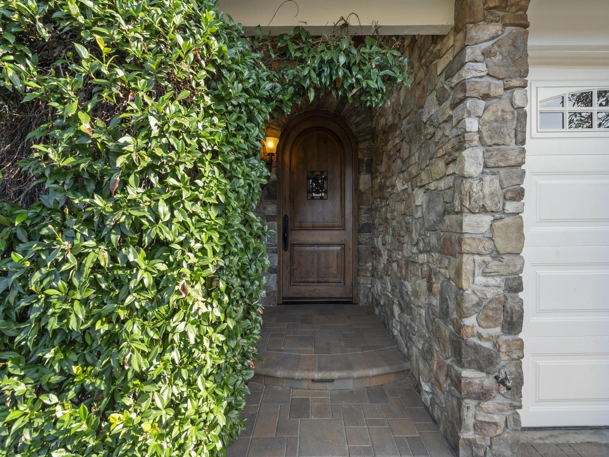 6502 La Paloma Street Carlsbad, CA 92009 - Photo 6 of 60 a view of entryway with flower plants