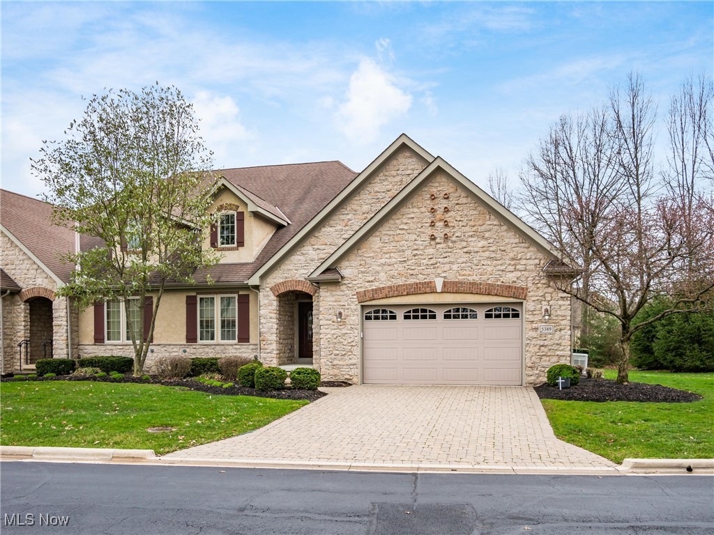 5349 Slater Ridge Westerville, OH 43082 - Photo 1 of 50 View of front of house with stone siding, a front yard, and decorative driveway